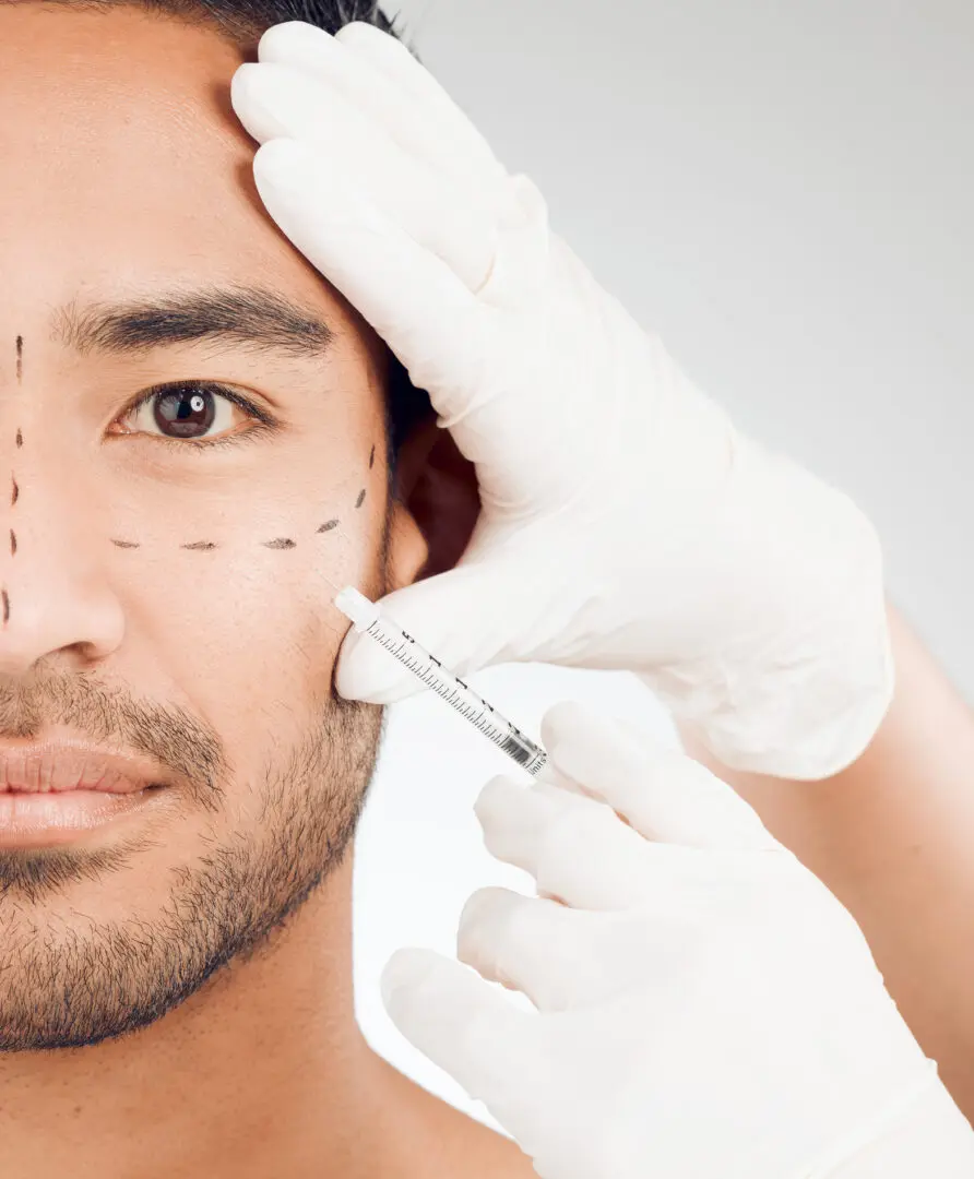 A man getting his face waxed by an esthetician.